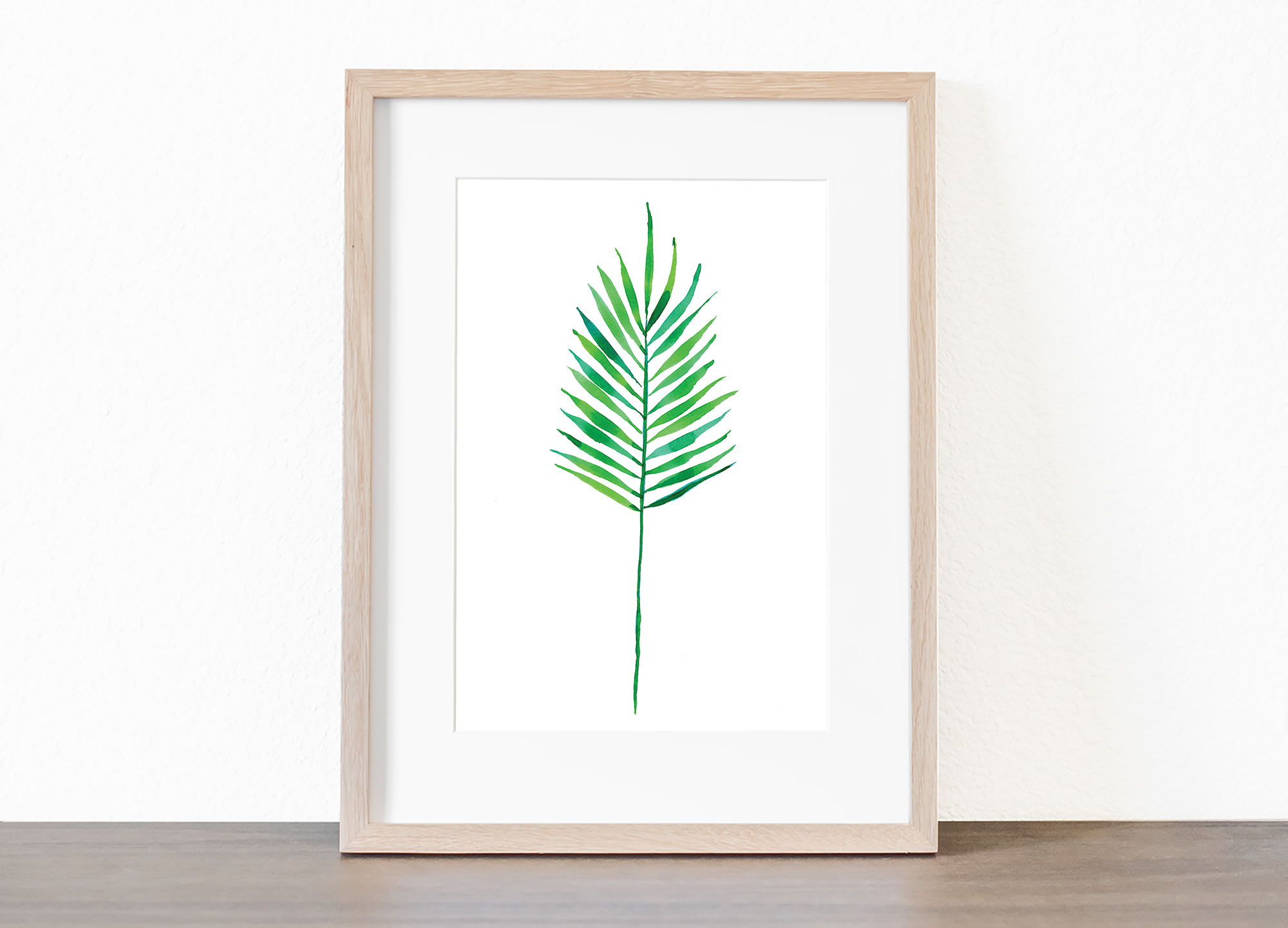 Watercolor palm leaf in soft green and turquoise tones on a clean white background.